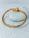 industrial-edge-nail-design-gold-bangle