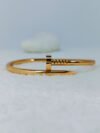 industrial-edge-nail-design-gold-bangle