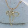 chic-ribbon-bow-gold-pendant-necklace